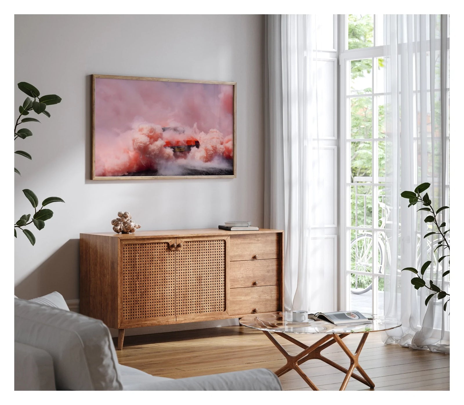 Framed in timber, shown in a contemporary living scene. We see a orange Holden sedan bearing the number plate LITMUP performing a burnout, the car almost entirely consumed by the vast churning cloud of pink/orange tyre smoke that fills the whole frame. The roofline and rear window are just visible through the enveloping haze as pink smoke billows in every direction across the velvety black bitumen below. Fine art colour photographic print by Simon Davidson.