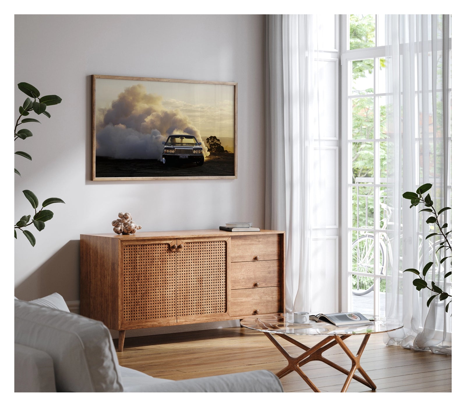 Framed in timber. Front view of a WB Holden ute performing a poetic burnout at golden hour, smoke billowing behind it like an approaching thunderstorm. Fading sunlight catches the haze and chrome as the car stays ahead of its own chaos. Shown in a contemporary living space. Fine art print by Simon Davidson.
