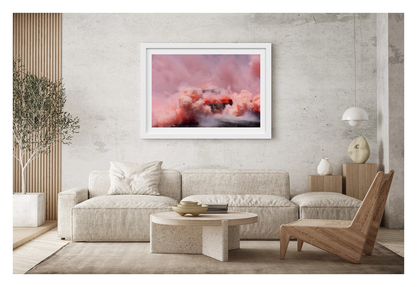 Framed in white, shown in a contemporary living scene. We see a orange Holden sedan bearing the number plate LITMUP performing a burnout, the car almost entirely consumed by the vast churning cloud of pink/orange tyre smoke that fills the whole frame. The roofline and rear window are just visible through the enveloping haze as pink smoke billows in every direction across the velvety black bitumen below. Fine art colour photographic print by Simon Davidson.