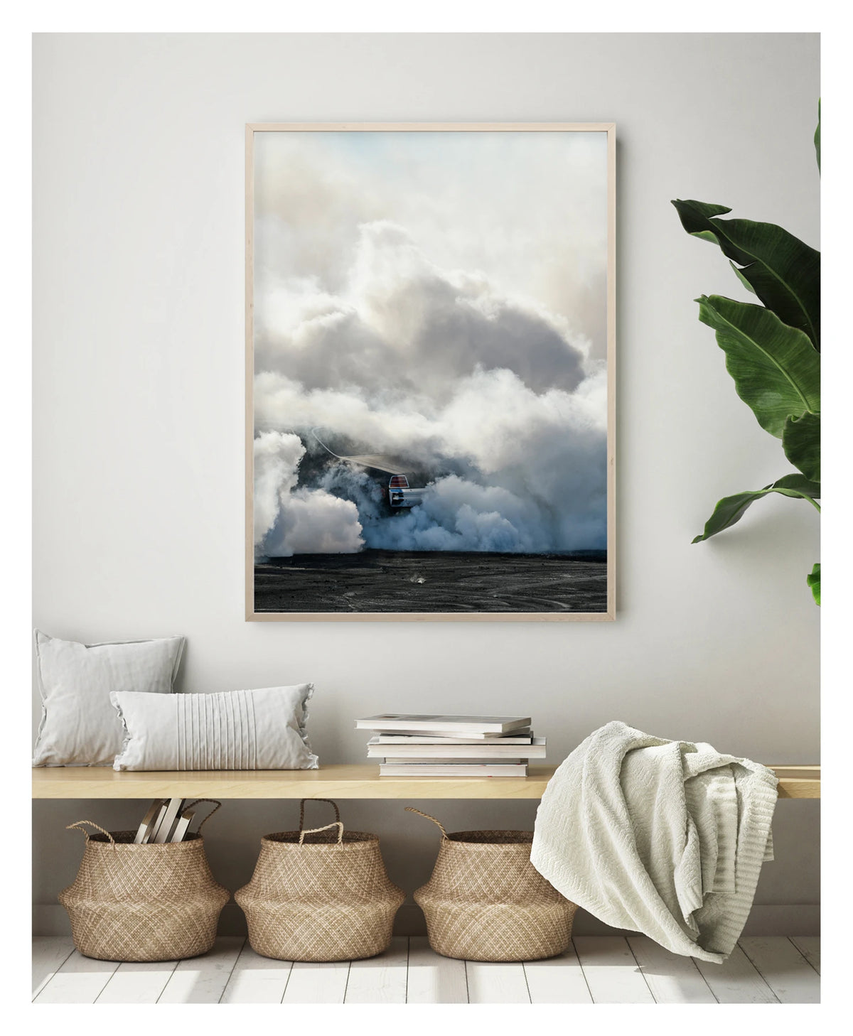 Framed in timber, displayed in a contemporary living space. We see rear of a black Holden GTS sedan is almost entirely swallowed by a towering cloud of white tyre smoke during a burnout, with only the red tail light and rear chrome bumper visible through the billowing haze. The smoke builds into a massive marshmallow like formation that fills the frame from the black bitumen covered in burnout detritus to the pale sky above, dwarfing the car beneath it. Fine art colour photographic print by Simon Davidson.
