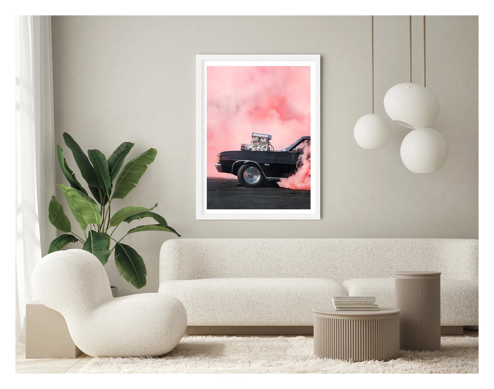 Framed in white. A black Chevrolet Chevelle SS with a massive polished supercharger protruding through the bonnet performs a burnout, engulfed in vivid pink tyre smoke that fills the entire background. The chrome blower and intake manifold gleam against the dark body as thick pink smoke pours from the under the car onto the tyre marked scorched black bitumen. Showing the framed print in a contemporary space. Fine art colour photographic print by Simon Davidson.