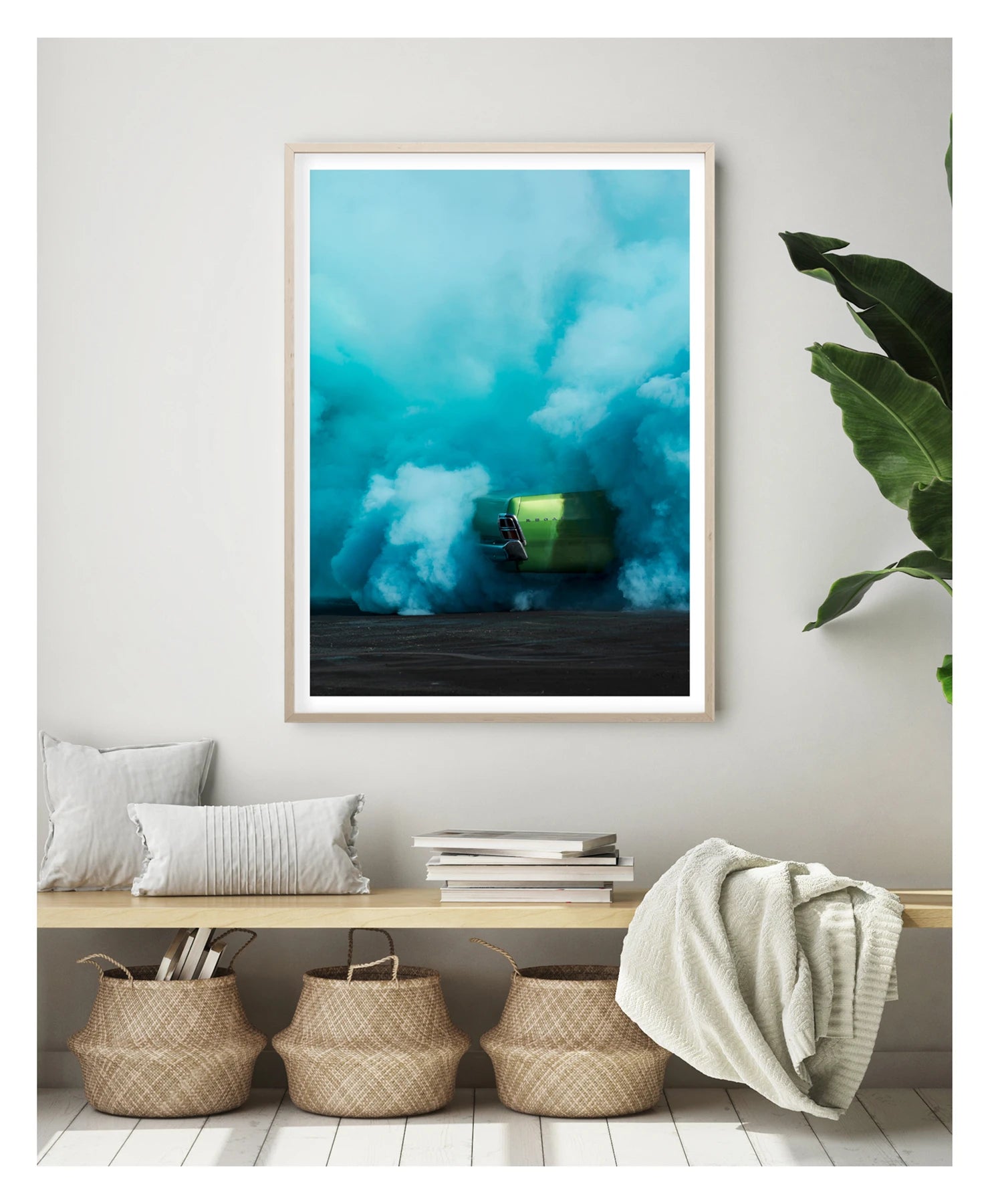 Framed in timber in a portrait orientation. The rear of metallic green Valiant Regal is almost completely consumed by a vast billowing cloud of vivid teal tyre smoke during a burnout. The electric contrast of the bright green body against the churning aqua smoke creates a striking abstract quality, the car appearing to float above the scorched black bitumen below. Framed print shown in a contemporary room. Fine art colour photographic print by Simon Davidson.