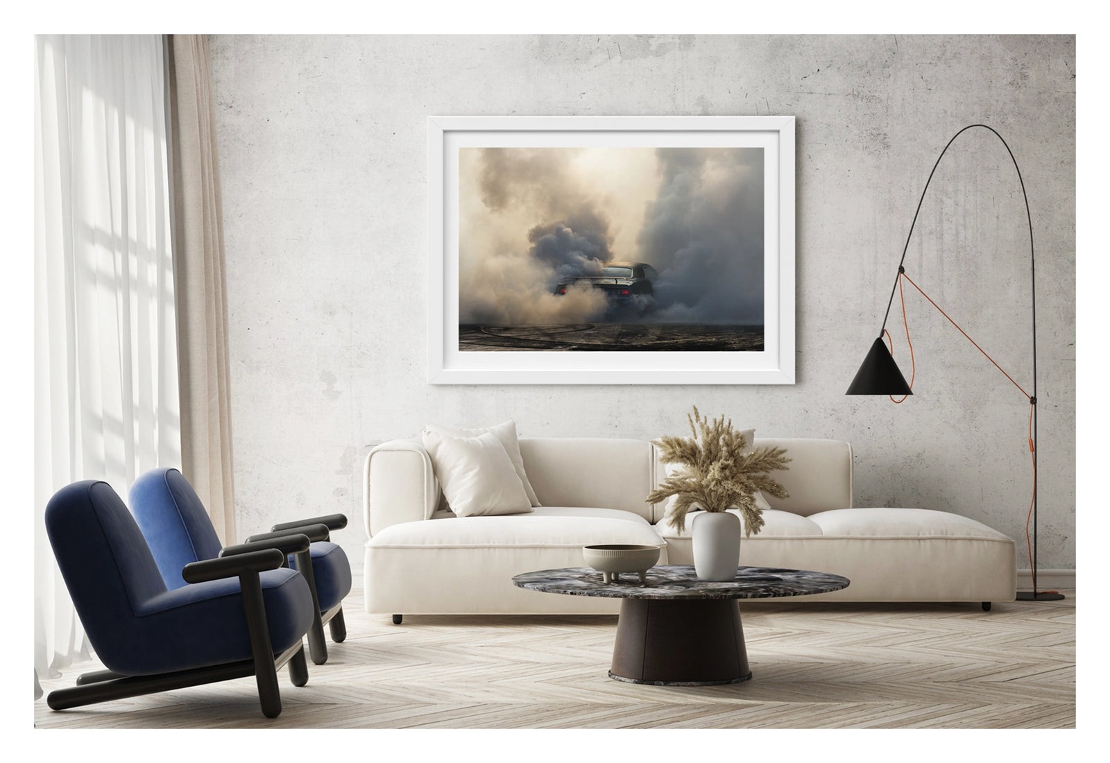 Framed in white, shown in a contemporary living space. We see the rear of a black Plymouth Barracuda with a vinyl roof performing a burnout, almost entirely consumed by billowing clouds of tyre smoke that fill the frame from ground to sky. Red tail lights glow through the haze, rubber marks streak the bitumen below. Fine art colour photographic print by Simon Davidson.