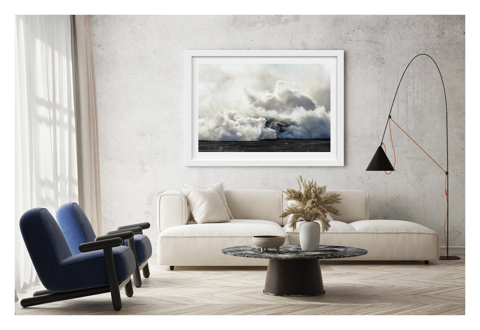Framed in white, displayed in a contemporary living space. The rear of a black Holden GTS sedan is almost entirely swallowed by a towering cloud of white tyre smoke during a burnout, with only the red tail light and rear chrome bumper visible through the billowing haze. The smoke builds into a massive marshmallow like formation that fills the frame from the black bitumen covered in burnout detritus to the pale sky above, dwarfing the car beneath it. Fine art colour photographic print by Simon Davidson.
