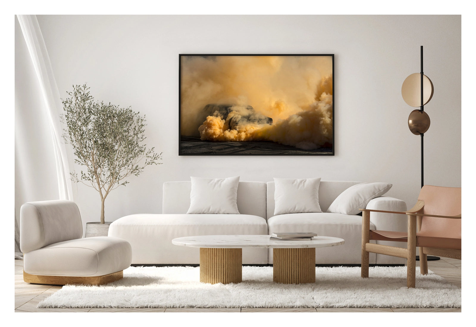 Framed in black, shown in a contemporary living space. A black Holden Holden sedan is almost near consumed by a towering cloud of deep amber and orange tyre smoke that fills the entire frame, the roofline and windscreen barely visible through the churning golden haze. The warm orange smoke billows dramatically in every direction across the marked black bitumen, giving the scene an almost volcanic intensity. Fine art colour photographic print by Simon Davidson.