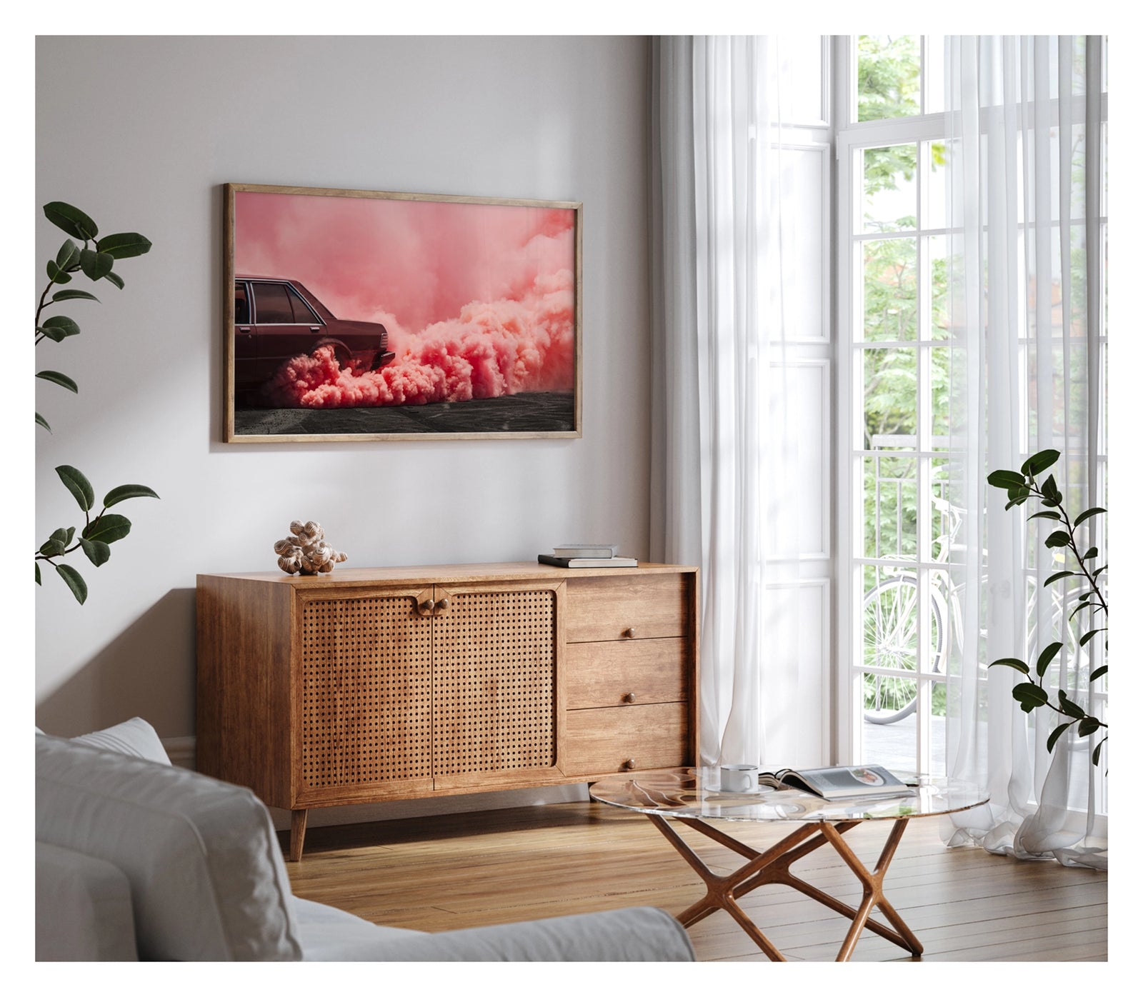 Framed in timber, shown in a contemporary living space. The visible rear lefthand quarter of a dark burgundy Ford Falcon sedan is mid burnout, a massive rolling cloud of vivid pink tyre smoke erupting from the rear wheel arch and sweeping across the full width of the frame. The deep red body of the car sits in rich tonal harmony with the warm pink smoke that floods the sky above and rolls heavily across the tyre marked burnout pad. Fine art colour photographic print by Simon Davidson. 